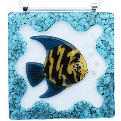 This is a square fused glass artwork featuring a tropical fish with yellow and black stripes and blue fins. It’s surrounded by a textured border of turquoise bubbles, giving the piece an underwater feel with small raised bubbles near the fish’s mouth.