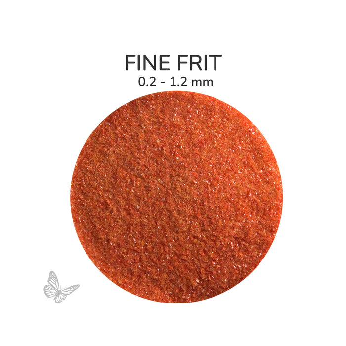 Close-up of Bullseye Red Opalescent 000124 Fine Frit showing 0.2 to 1.2 mm particles.