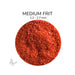 Close-up of Bullseye Red Opalescent 000124 Medium Frit showing 1.2 to 2.7 mm particles.