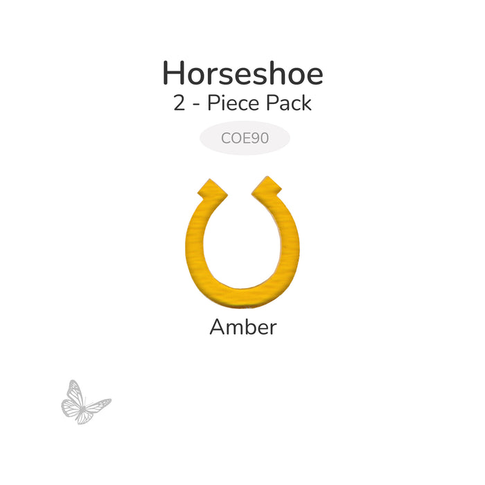 Amber horseshoe-shaped fusible glass cutout, 2-piece pack, COE90, shown on light gray background.