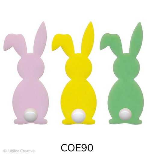 image of two fusible precut glass bunnies with a cotton ball for a tail. Available in opaque pink, yellow, and green - COE90