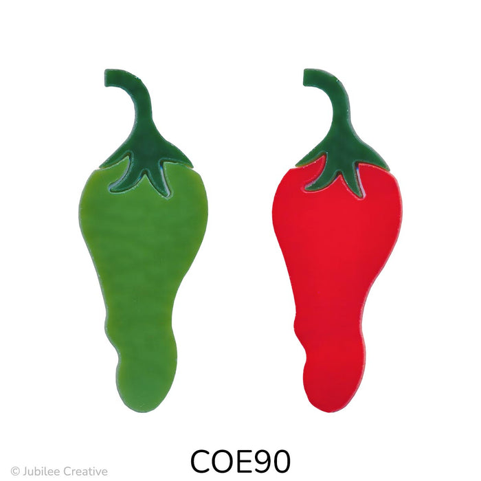 image of two fusible precut glass chili peppers. one is green and one is red. both have a dark green top. COE90