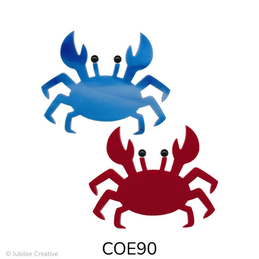 image of two fusible precut glass crabs. One is a wispy blue and the other is red. Both feature two black glass dots for eyes - COE90