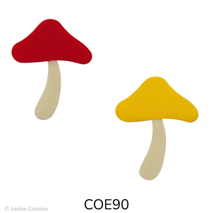 image of two precut glass mushroom one with a red top and ivory stem and the other with a yellow top and an ivory stem - COE90