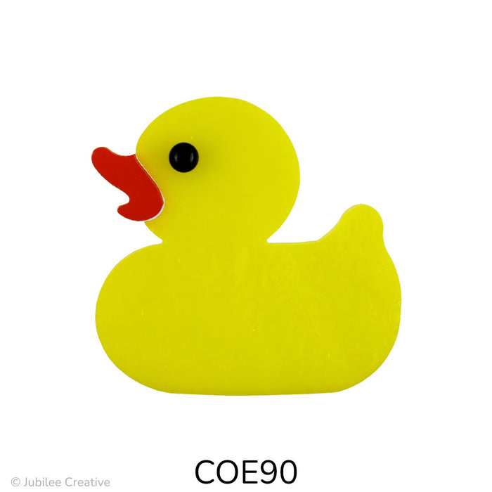 image of a fusible precut yellow glass rubber duck featuring a black eye and orange beak - COE90