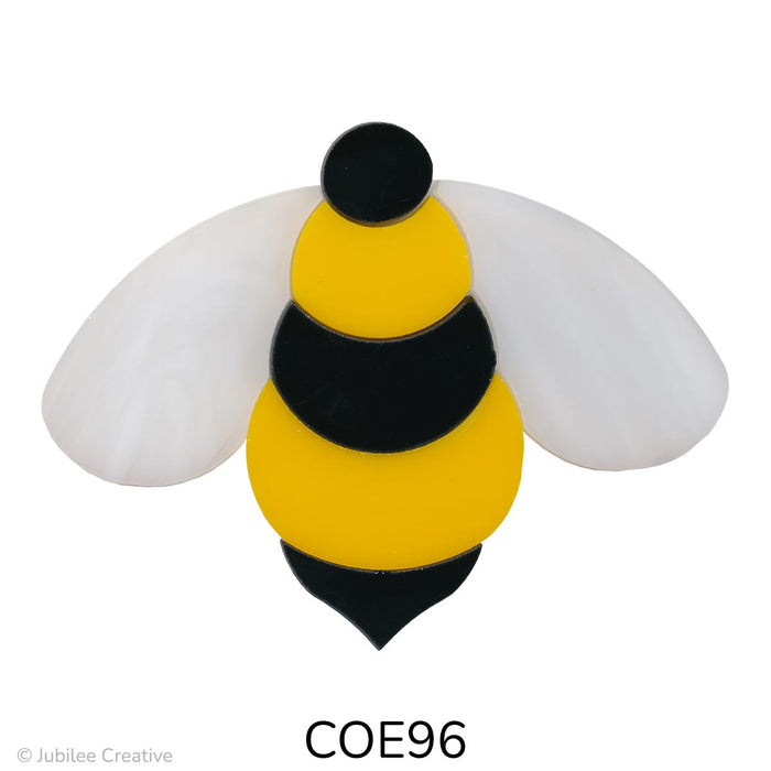 image of a fusible precut glass bumble be with a black and yellow stripped body and white wispy wings - COE0