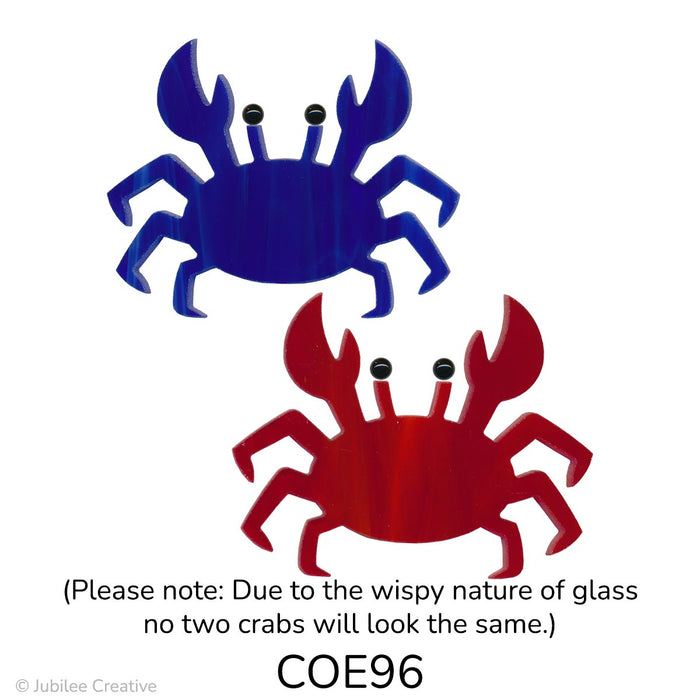 image of two fusible precut glass crabs. One is a wispy blue and the other is wispy red. Both feature two black glass dots for eyes - COE96