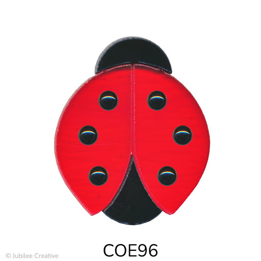 image of a precut fusible glass ladybug with a black head, tail, and dots on a translucent red body - COE90