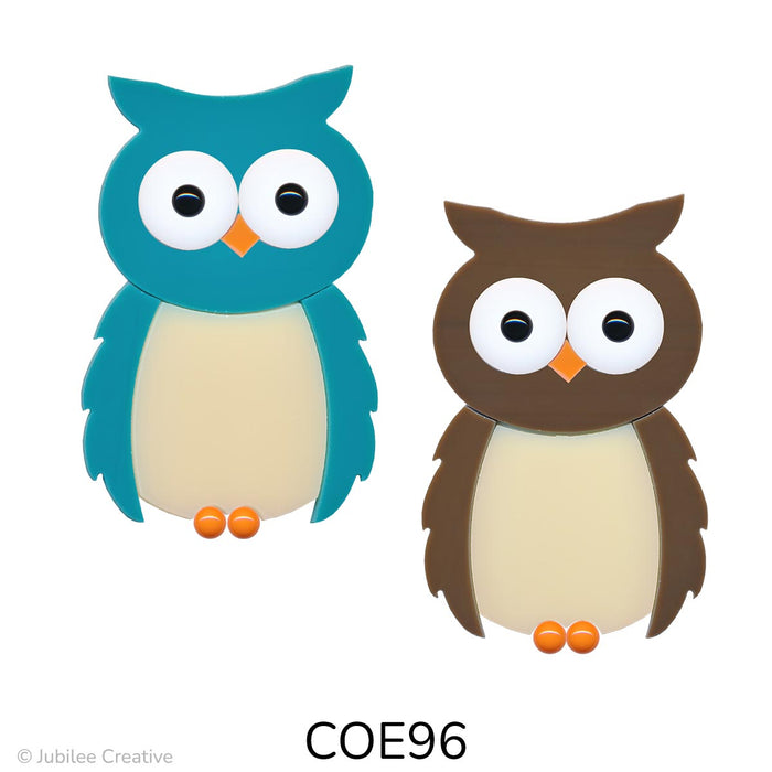 image of a brown and a teal green fusible precut glass owl.  They have white eyes with black pupil, orange beak and feet - COE96