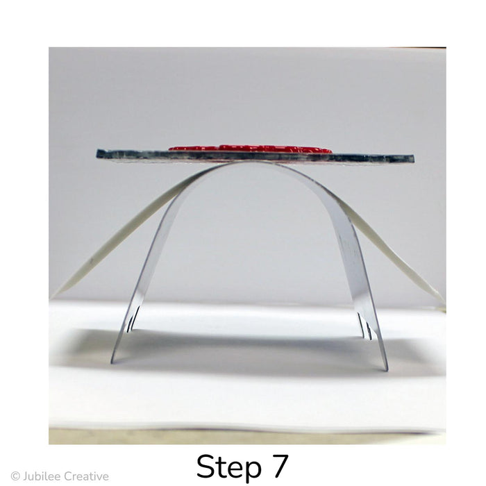 image of Step 7. Cut a piece of fusing paper the length and width of the mold. Place mold in your kiln. It is not necessary to elevate the mold on kiln posts. Next, balance the fusing paper and your glass project on top of the mold and fire using your kiln's standard slump firing schedule.