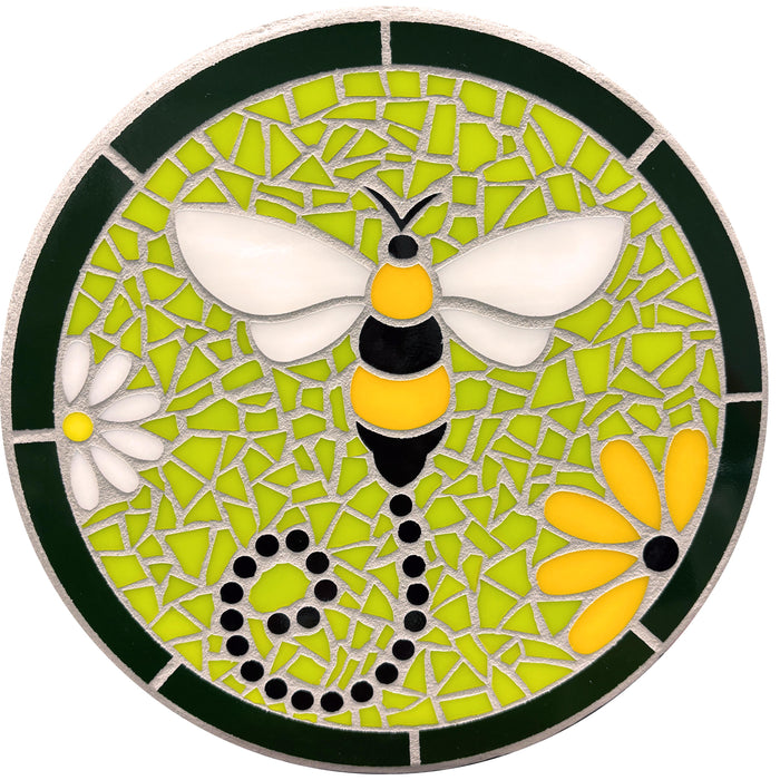 This circular mosaic steppingstone features a vibrant bee with yellow and black stripes, white wings, and a playful dotted swirl for its trail. Set against a lime-green mosaic background with a dark green border, the design includes a white and a yellow daisy for added charm. Silver grout ties the piece together, making it a colorful and eye-catching addition to gardens or pathways.