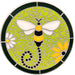 This circular mosaic steppingstone features a vibrant bee with yellow and black stripes, white wings, and a playful dotted swirl for its trail. Set against a lime-green mosaic background with a dark green border, the design includes a white and a yellow daisy for added charm. Silver grout ties the piece together, making it a colorful and eye-catching addition to gardens or pathways.