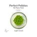 Assorted color round glass pebbles in a clear dish labeled Perfect Pebbles 50 Piece Pack COE90