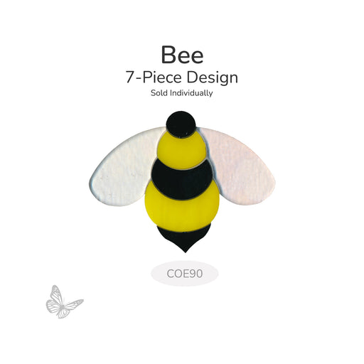 Bee glass design made from seven precut pieces in yellow, black, and white, shown unfused on a white background