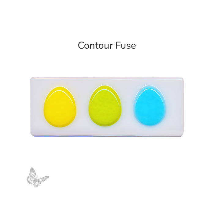 Contour fused egg-shaped glass pieces showing rounded edges after firing.