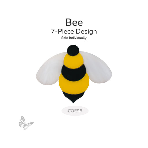 Bee glass design made from seven precut pieces in yellow, black, and white, shown unfused on a white background