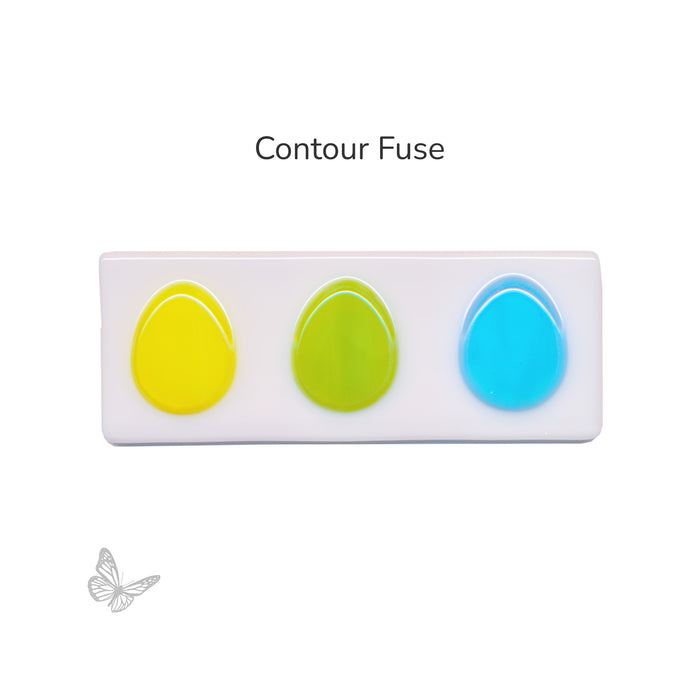 Contour fused egg-shaped glass pieces showing rounded edges after firing.