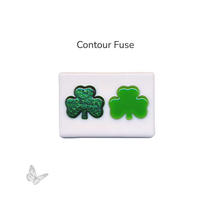 Bullseye COE90 shamrock glass shapes shown after contour fuse on white glass