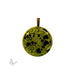Round glass pendant with black heart and swirl pattern on a green iridized background