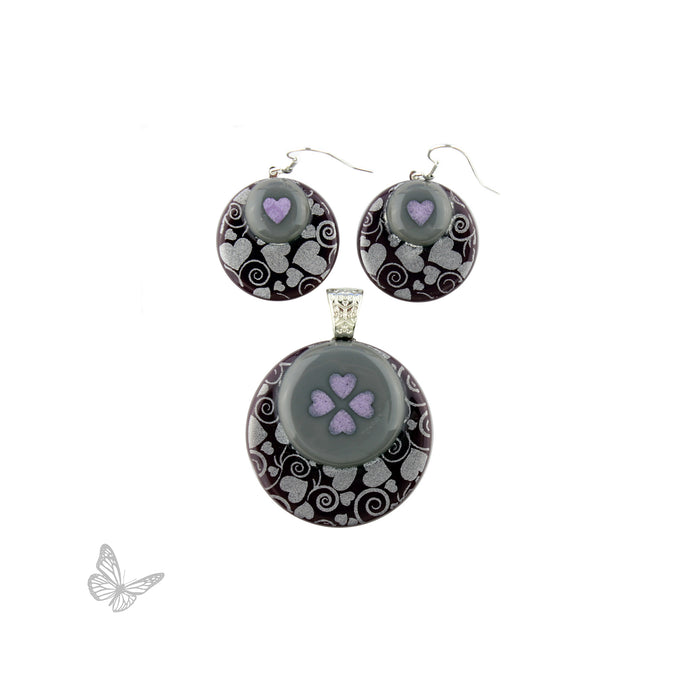 Example of finished fused glass jewelry using layered glass circles, shown as earrings and pendant.